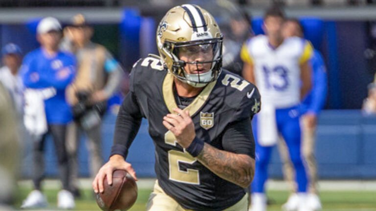 Spencer Rattler of the New Orleans Saints scrambles to find a receiver during an NFL preseason game between against the Los Angeles Rams